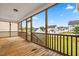 A screened porch with wooden floors and a view of the community at 44 Good Morning Ln, Garner, NC 27529