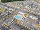 Aerial view of community pool, clubhouse and playground surrounded by townhomes at 5910 Giddings St, Raleigh, NC 27616