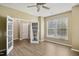 Bright bedroom with a ceiling fan, wood flooring, and double doors leading to an additional room at 5910 Giddings St, Raleigh, NC 27616