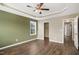 Comfortable bedroom featuring hardwood floors, a ceiling fan, and a walk-in closet at 5910 Giddings St, Raleigh, NC 27616