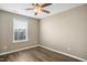 Comfortable bedroom with hardwood floors, a ceiling fan, and a window at 5910 Giddings St, Raleigh, NC 27616