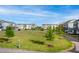 Townhome community with green space and playground on a sunny day at 5910 Giddings St, Raleigh, NC 27616