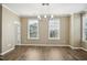 Bright dining room featuring hardwood floors, modern chandelier, and large windows at 5910 Giddings St, Raleigh, NC 27616