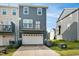 Back of the home with a two-car garage and upstairs deck at 5910 Giddings St, Raleigh, NC 27616