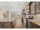 Modern kitchen with granite countertops, stainless steel appliances, and dark wood cabinetry at 5910 Giddings St, Raleigh, NC 27616