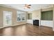 Open-concept living room with wood floors, a fireplace, and built-in shelving at 5910 Giddings St, Raleigh, NC 27616