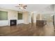 Open-concept living space with wood floors, a fireplace, and a view of the kitchen at 5910 Giddings St, Raleigh, NC 27616