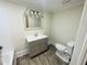 Bathroom with a vanity, mirror, updated lighting, and a toilet at 602 Dexter St, Rocky Mount, NC 27803