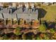 Aerial view of rooftops, fenced backyards, mature trees, and community landscaping at 635 Grace Hodge Dr, Cary, NC 27519