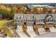 Aerial view of well-maintained townhomes surrounded by mature trees in a desirable community at 635 Grace Hodge Dr, Cary, NC 27519