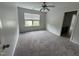 Bedroom with neutral walls, carpet floors, a ceiling fan, and views of neighborhood at 635 Grace Hodge Dr, Cary, NC 27519