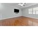 Spacious room featuring hardwood flooring, ceiling fan, and large window with blinds at 635 Grace Hodge Dr, Cary, NC 27519