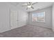 Bedroom featuring carpet floors, neutral walls, closet, ceiling fan, and windows at 635 Grace Hodge Dr, Cary, NC 27519