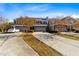 Wide shot of townhomes with garages, landscaping, and a long driveway on a sunny day at 635 Grace Hodge Dr, Cary, NC 27519