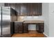 A modern kitchen with stainless steel refrigerator and matching dark brown cabinetry at 635 Grace Hodge Dr, Cary, NC 27519