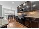 Gourmet kitchen featuring stainless steel appliances, granite countertops, and dark wood cabinets at 635 Grace Hodge Dr, Cary, NC 27519