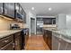 Gourmet kitchen with stainless steel refrigerator and appliances, and granite countertop at 635 Grace Hodge Dr, Cary, NC 27519