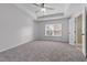Spacious main bedroom with tray ceiling, neutral walls, and a window with blinds at 635 Grace Hodge Dr, Cary, NC 27519