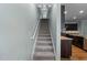 Staircase leading upstairs has carpeted steps and white handrail at 635 Grace Hodge Dr, Cary, NC 27519