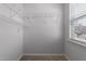 Walk-in closet featuring neutral walls, carpet floors, white wire shelving, and natural light at 635 Grace Hodge Dr, Cary, NC 27519