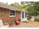 A charming back porch with red brick, a window, and a door to the home's interior at 6517 Whitted Rd, Fuquay Varina, NC 27526