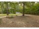 Large backyard with scattered trees and a view of the detached building at 6517 Whitted Rd, Fuquay Varina, NC 27526