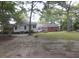 Backyard view of the house from the yard, surrounded by trees at 6517 Whitted Rd, Fuquay Varina, NC 27526