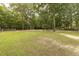 Large, lush backyard with mature trees, offering privacy and space for outdoor activities at 6517 Whitted Rd, Fuquay Varina, NC 27526