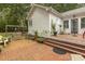 Cozy backyard patio with a porch swing, potted plants, and wood deck at 6517 Whitted Rd, Fuquay Varina, NC 27526