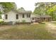 View of the back of the house with a brick patio area and partial fencing at 6517 Whitted Rd, Fuquay Varina, NC 27526