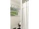 Bathroom featuring a window with white blinds and a decorative white shower curtain at 6517 Whitted Rd, Fuquay Varina, NC 27526
