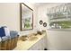 Bathroom featuring a vanity with drawers, vintage wallpaper and a large mirror with a view at 6517 Whitted Rd, Fuquay Varina, NC 27526
