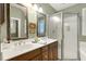 Bathroom featuring a double vanity with framed mirrors and a glass-enclosed shower at 6517 Whitted Rd, Fuquay Varina, NC 27526