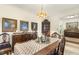 A charming dining room featuring a wooden table with blue chairs and vintage decor at 6517 Whitted Rd, Fuquay Varina, NC 27526