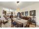 A beautiful dining room featuring a table with blue cushioned chairs and a vintage chandelier at 6517 Whitted Rd, Fuquay Varina, NC 27526