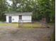 Exterior view of a detached garage or shed, featuring a fenced area for animals at 6517 Whitted Rd, Fuquay Varina, NC 27526
