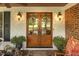 Charming front entrance featuring double doors adorned with wreaths and decorative plants, enhancing curb appeal at 6517 Whitted Rd, Fuquay Varina, NC 27526