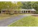 Beautiful brick home featuring a covered front porch and a spacious circular driveway at 6517 Whitted Rd, Fuquay Varina, NC 27526