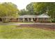 Charming brick ranch-style home with a welcoming front porch and well-manicured landscaping at 6517 Whitted Rd, Fuquay Varina, NC 27526