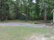 View of the front yard and mature trees surrounding the home at 6517 Whitted Rd, Fuquay Varina, NC 27526