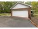 Spacious detached garage with a white door and brick siding, offering ample parking space at 6517 Whitted Rd, Fuquay Varina, NC 27526