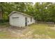 View of detached one-car garage with white siding and landscaping at 6517 Whitted Rd, Fuquay Varina, NC 27526