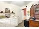 Hallway featuring a small refrigerator and a utility table with drawers at 6517 Whitted Rd, Fuquay Varina, NC 27526