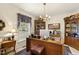 Cozy home office with wood desk, soft lighting, and floral accents creates an inviting workspace at 6517 Whitted Rd, Fuquay Varina, NC 27526