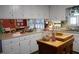 Traditional eat-in kitchen featuring white cabinets, an island, and stainless steel appliances at 6517 Whitted Rd, Fuquay Varina, NC 27526