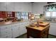 Traditional eat-in kitchen featuring white cabinets, an island, and stainless steel appliances at 6517 Whitted Rd, Fuquay Varina, NC 27526