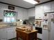 Traditional eat-in kitchen featuring white cabinets, an island, and stainless steel appliances at 6517 Whitted Rd, Fuquay Varina, NC 27526