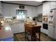 Traditional eat-in kitchen featuring white cabinets, an island, and stainless steel appliances at 6517 Whitted Rd, Fuquay Varina, NC 27526