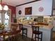 Kitchen and eat-in bar area with white cabinetry and casual seating, perfect for gathering and quick meals at 6517 Whitted Rd, Fuquay Varina, NC 27526
