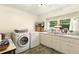 Bright laundry room with modern appliances, window and sink at 6517 Whitted Rd, Fuquay Varina, NC 27526
